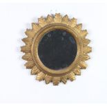 A Georgian style circular mirror contained in a carved oak sunburst frame 31cm diam.