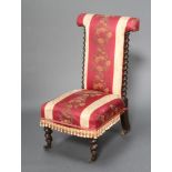 A Victorian prie dieu chair upholstered in pink and red floral material with spiral turned columns