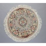 A white and floral patterned circular Chinese rug 98cm diam.