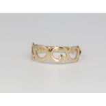 A 9ct yellow gold open ring, size N, 1.2 grams