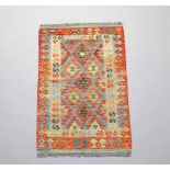 An orange and green ground Chobi Kilim rug 121cm x 76cm