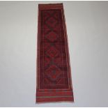 A blue and red ground Meshwani runner with 4 diamonds to the centre within a multi row border