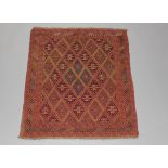 A red and tan ground Gazak rug with all over diamond design 136cm x 121cm