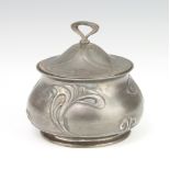 A WMF Art Nouveau circular repousse ex plated pot decorated with stylised flowers with glass liner