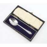 A silver teaspoon with engraved monogram, London 1927, 22 grams, boxed