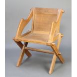 An oak Glastonbury chair The brass plaque has been removed from the back of the chair and there is a
