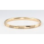 A 9ct yellow gold engraved bangle 5.7 grams