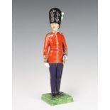 A Dresden figure of a standing Welsh guardsman 27cm