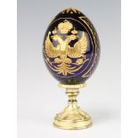 A Faberge Collection Romanov eagle egg on a gilt metal base 15cm, boxed