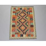 A green, black and orange ground Chobi Kilim rug with geometric designs 142cm x 100cm