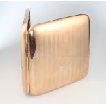 A 9ct yellow gold engine turned cigarette case 118 grams gross including spring, Birmingham 1919