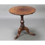 A 19th Century circular mahogany tea table, raised on a turned column and tripod base 66cm h x