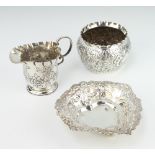 An Edwardian repousse silver cream jug Chester 1901, a bowl and bon bon dish, 150 grams