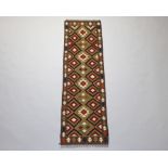 A black, white and brown ground Maimana Kilim runner with diamond decoration 205cm x 61cm