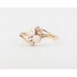 A 9ct yellow gold crossover pearl and diamond ring rize K, 1.1 grams