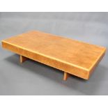 An Art Deco style rectangular figured walnut coffee table raised on panel supports 37cm h x 159cm