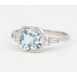 An Edwardian style platinum aquamarine and diamond ring, the centre square cut stone approx. 2.1ct