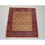 A brown and red ground Persian rug with geometric designs to the centre 155cm x 129cm