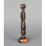 A curious lignum vitae carved figure of 2 back to back ladies, raised on a turned base 22cm x 5cm