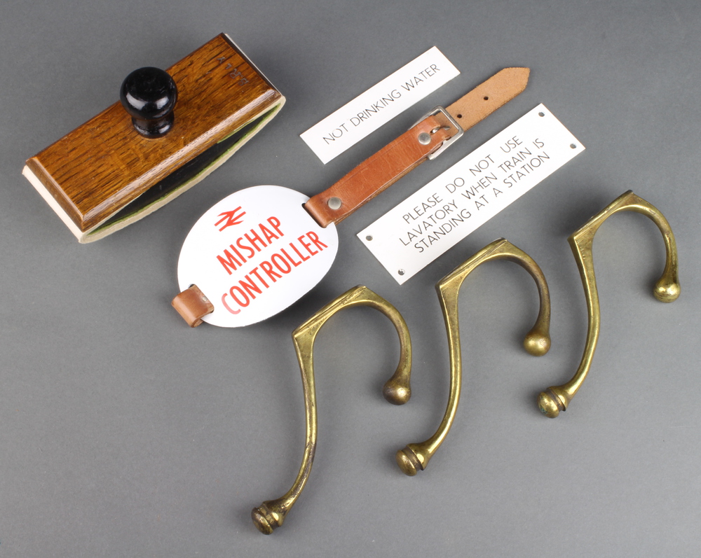 Three brass London South Western Railway hat and coat hooks, a Southern Railways oak desk blotter, a