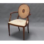 A Georgian style mahogany open armchair with cane work back and Berlin wool work seat, raised on