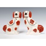 A pair of Victorian Staffordshire Spaniels with ochre decoration 22cm