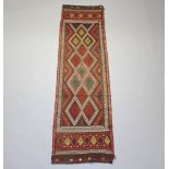 A Suzni Kilim runner with all over diamond design 272cm x 75cm