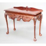 Higginbottom of Dublin, a Georgian style carved mahogany serving table with raised back, raised on