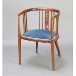 An Edwardian inlaid mahogany stick and rail back tub back chair, seat upholstered in blue material