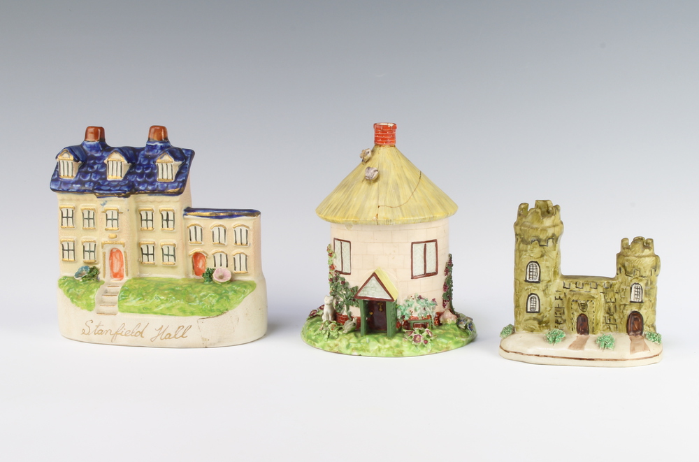 A Victorian Staffordshire castle 10cm, a ditto house 14cm and a circular thatched cottage with
