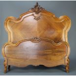 A 19th Century French carved walnut double bedstead complete with associated side irons 159cm h x