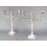 A pair of silver plated 3 light candelabra on tapered stems 48cm