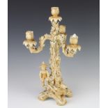 A German porcelain candelabrum with 4 lights, the base in the form of a rustic tree with children