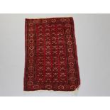 An Afghan red and white ground rug the central field with multiple medallions within a multi row