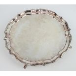A silver salver with Chippendale rim and presentation inscription, on hoof feet, Sheffield 1995,