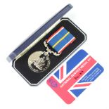 A cased National Service medal