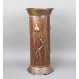 An Art Nouveau cylindrical embossed brass stick stand raised on a spreading foot 57cm h x 25cm The