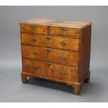 A Queen Anne walnut chest of 2 short and 3 long drawers with quarter veneered and feather banded