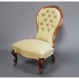 A Victorian carved mahogany show frame nursing chair upholstered in green buttoned material,