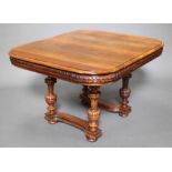 A 19th Century Continental walnut dining table raised on 4 turned and fluted columns with carved