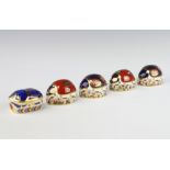Five Royal Crown Derby Imari pattern Ladybird paperweights, 3 with gold stoppers, 2 with silver