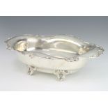 A Sterling silver bowl on scroll feet with floral rim and engraved monogram 29cm, 520 gramsThere are
