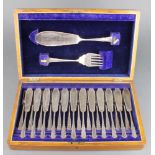 A set of silver plated fish eaters for 12 with servers contained in an oak canteen