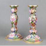 A pair of champleve enamelled club shaped candlesticks with floral decoration 23cm
