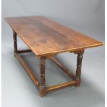 A 17th/18th Century oak refectory dining table, the top formed of 3 planks raised on turned and