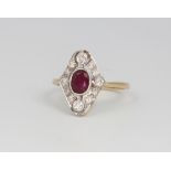 An 18ct yellow gold Edwardian style ruby and diamond cluster ring, the centre oval cut stone approx.