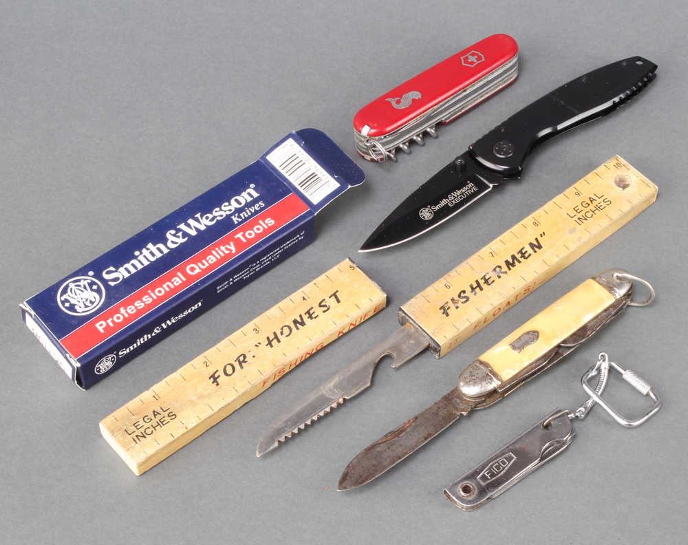 A Smith and Wesson folding knife with 7.5cm blade boxed, a Swiss Army pen knife, a multi bladed
