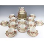 A Limoges tea set with rose and gilt decoration comprising cream jug, sugar bowl, 12 cups, 12