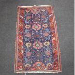 A red and blue ground Caucasian style rug 197cm x 110cm Some flecking throughout the rug