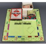 A Wartime Monopoly set with cardboard and wooden figures, wooden houses, complete with board